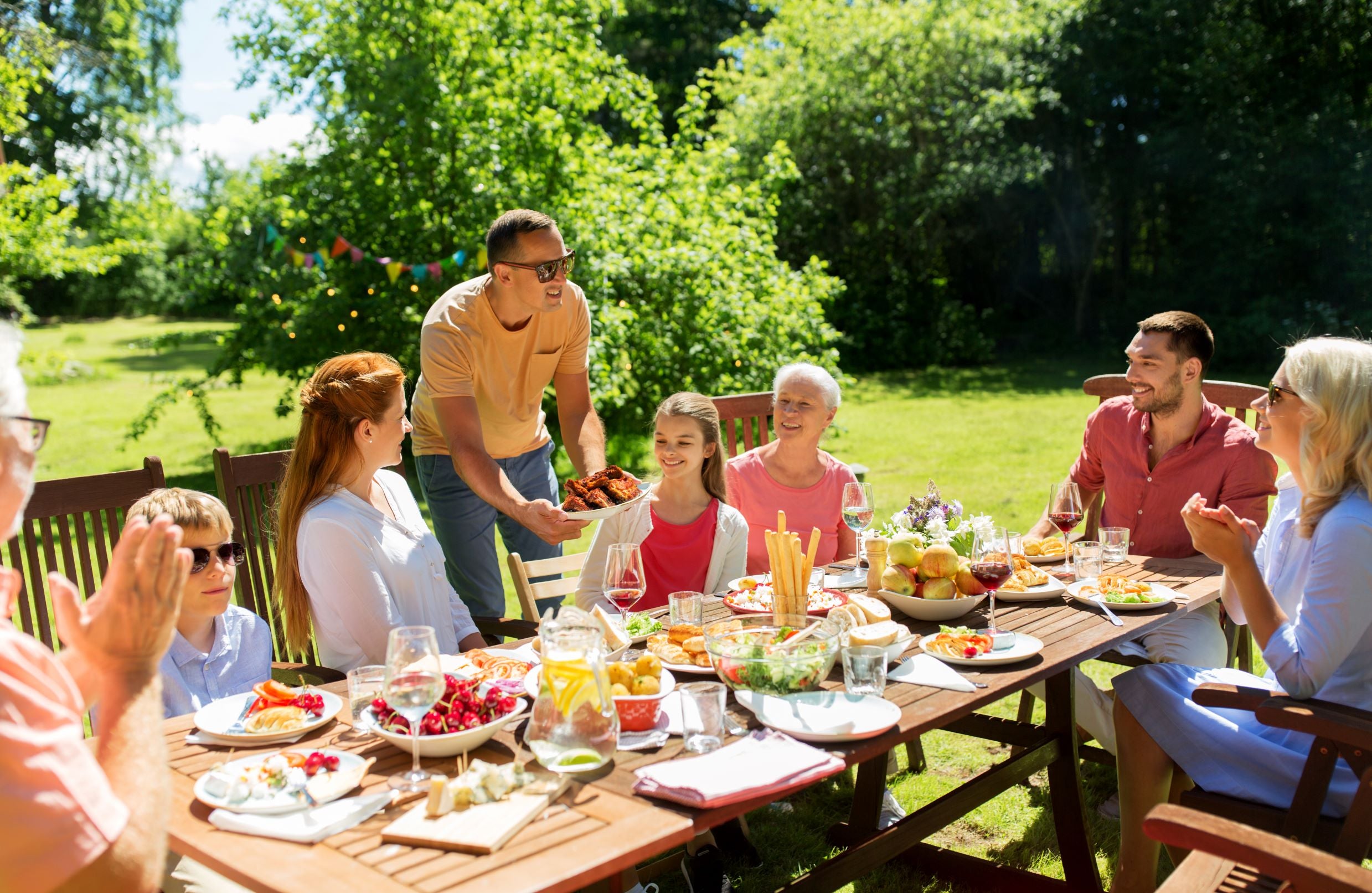 Happy family having an outdoor lunch together.