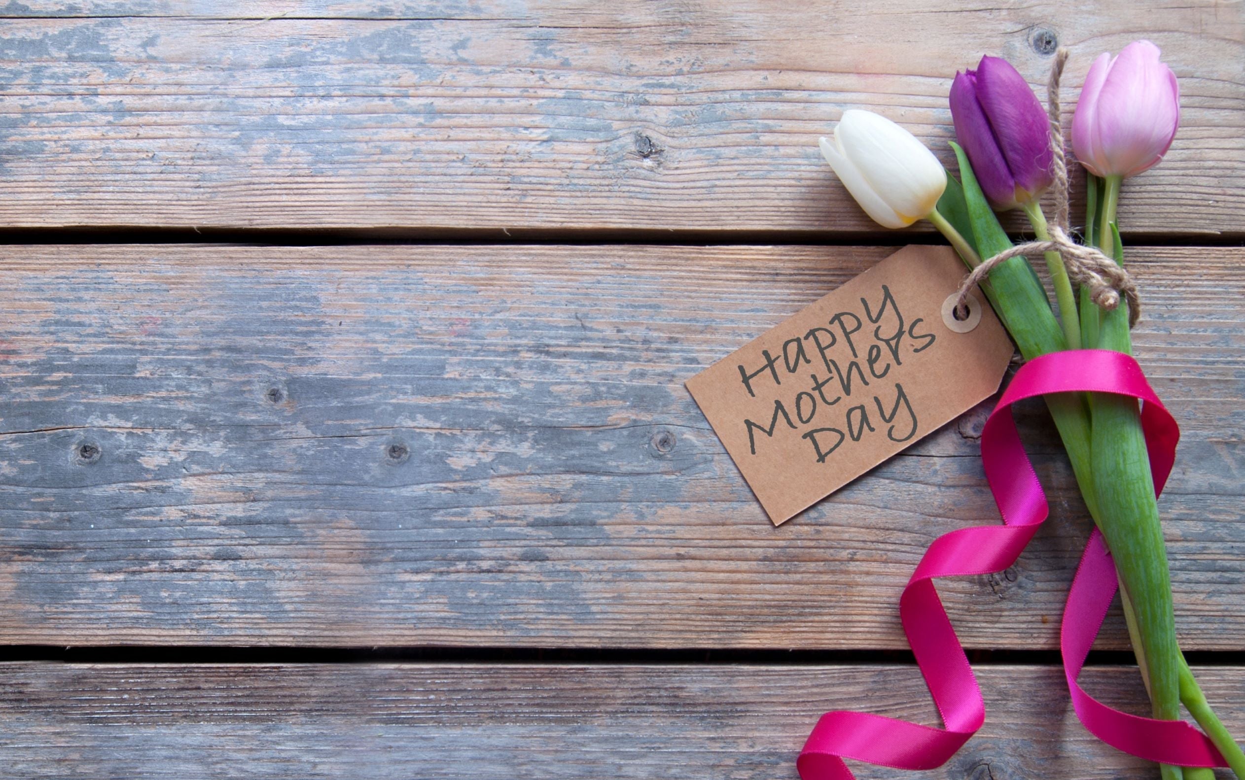 Mother's Day Tulip bouquet on a wooden surface.