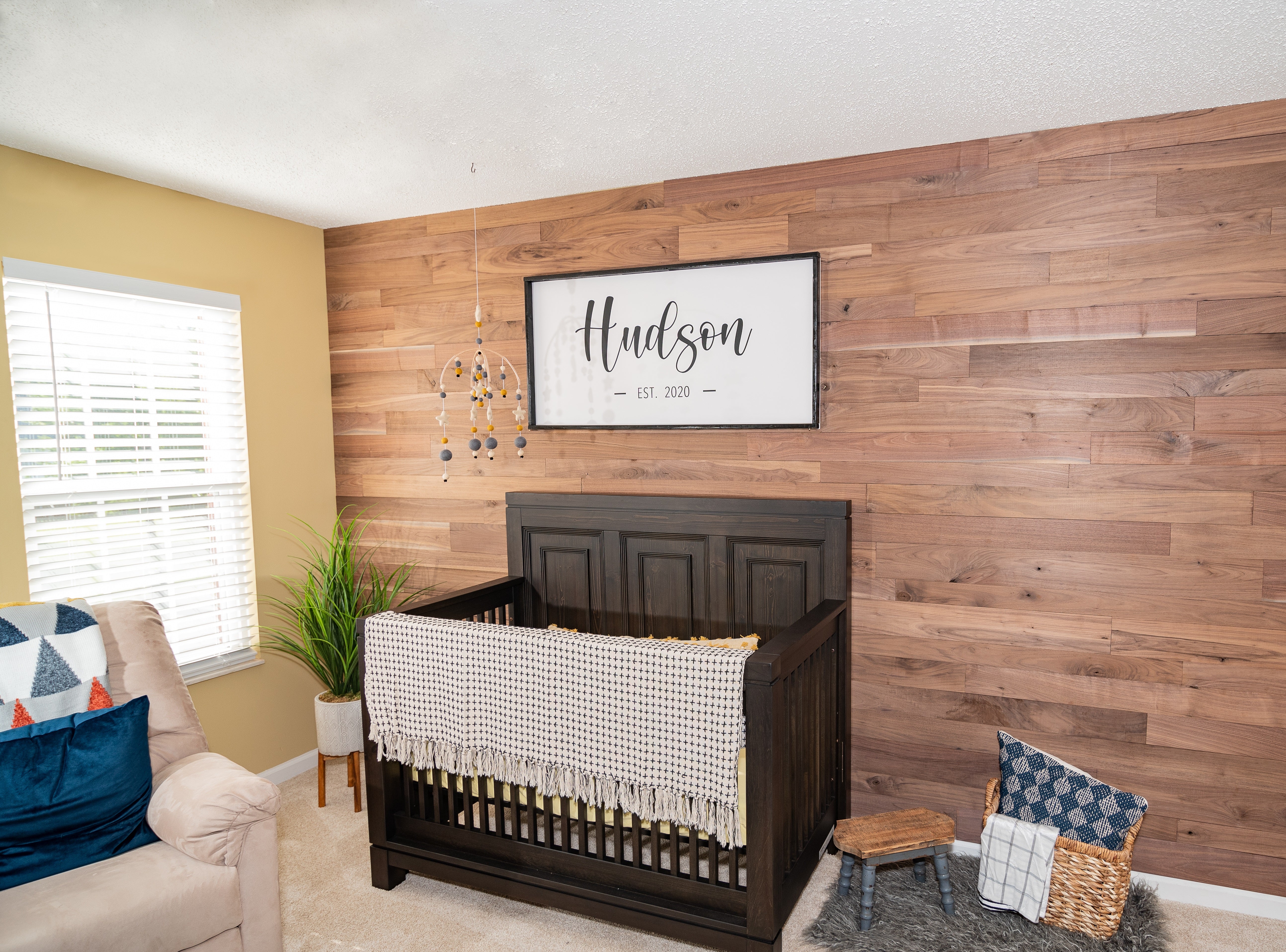 Walnut wood plank DIY wall in a  nursery.