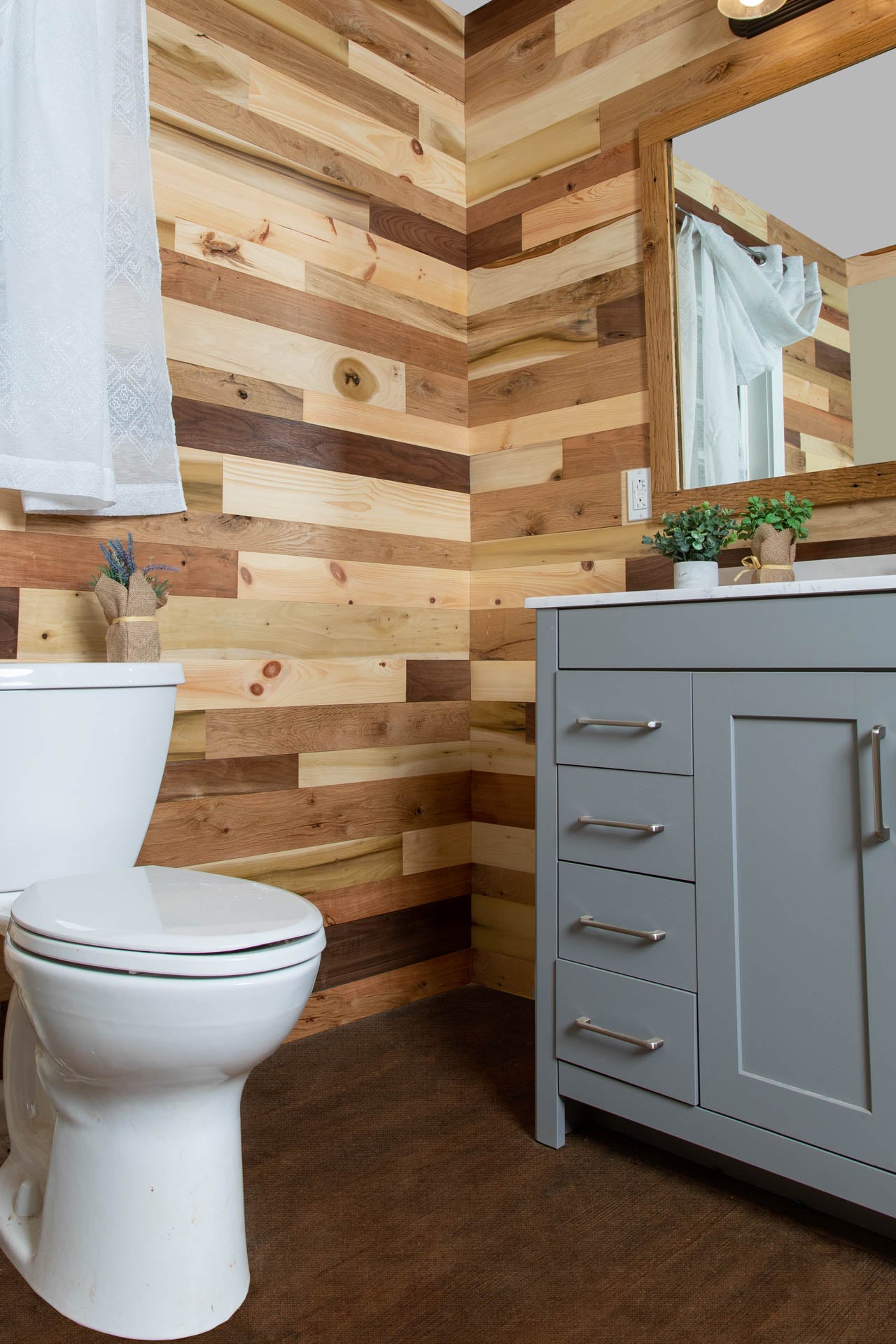 Vintage multicolored reclaimed wooden plank bathroom wall.