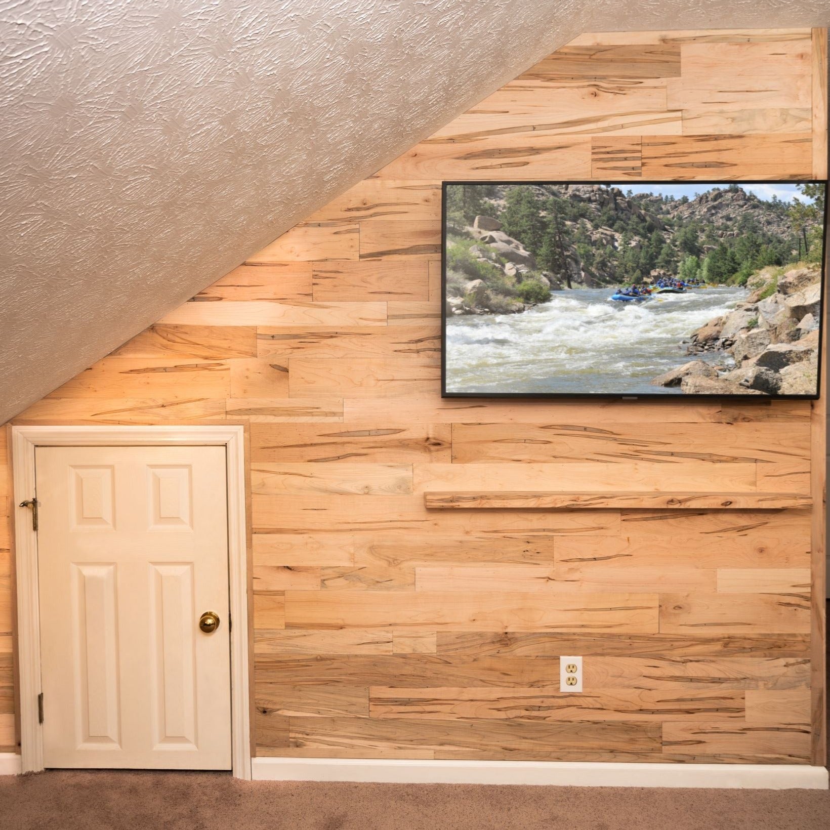 Ambrosia Maple wooden plank wall with a mounted TV.